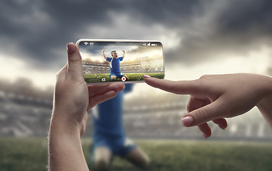 Image showing Close up hands holding smartphone viewing sport, online translation, streaming of championship