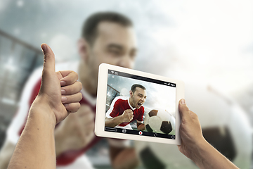 Image showing Close up hands holding tablet viewing sport, online translation, streaming of championship