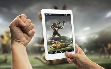 Image showing Close up hands holding tablet viewing sport, online translation, streaming of championship