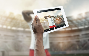 Image showing Close up hands holding tablet viewing sport, online translation, streaming of championship