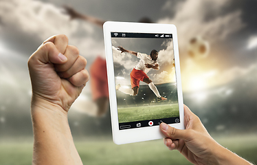 Image showing Close up hands holding tablet viewing sport, online translation, streaming of championship