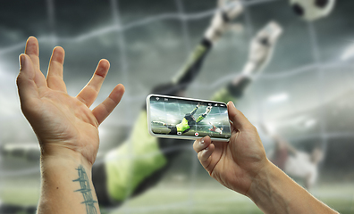 Image showing Close up hands holding smartphone viewing sport, online translation, streaming of championship