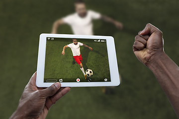 Image showing Close up hands holding tablet viewing sport, online translation, streaming of championship