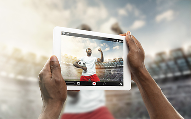 Image showing Close up hands holding tablet viewing sport, online translation, streaming of championship