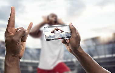 Image showing Close up hands holding smartphone viewing sport, online translation, streaming of championship