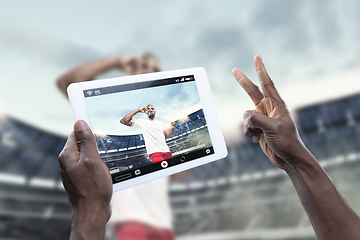 Image showing Close up hands holding tablet viewing sport, online translation, streaming of championship