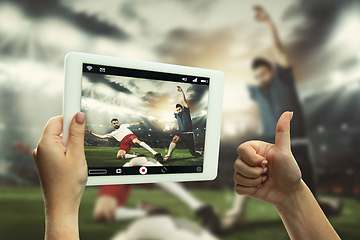 Image showing Close up hands holding tablet viewing sport, online translation, streaming of championship