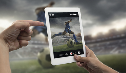 Image showing Close up hands holding tablet viewing sport, online translation, streaming of championship