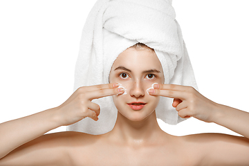 Image showing Beauty Day. Woman wearing towel doing her daily skincare routine isolated on white studio background