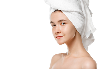 Image showing Beauty Day. Woman wearing towel doing her daily skincare routine isolated on white studio background