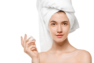 Image showing Beauty Day. Woman wearing towel doing her daily skincare routine isolated on white studio background