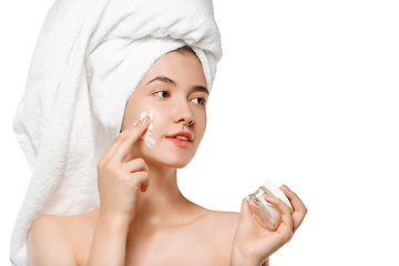 Image showing Beauty Day. Woman wearing towel doing her daily skincare routine isolated on white studio background