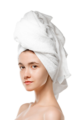 Image showing Beauty Day. Woman wearing towel doing her daily skincare routine isolated on white studio background