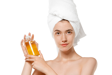 Image showing Beauty Day. Woman wearing towel doing her daily skincare routine isolated on white studio background