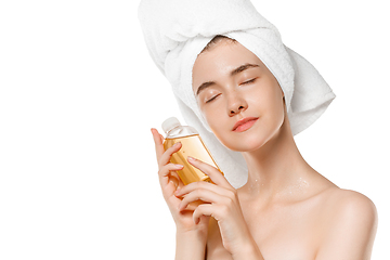 Image showing Beauty Day. Woman wearing towel doing her daily skincare routine isolated on white studio background