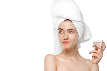 Image showing Beauty Day. Woman wearing towel doing her daily skincare routine isolated on white studio background