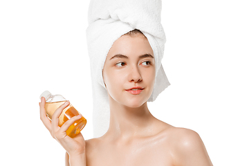 Image showing Beauty Day. Woman wearing towel doing her daily skincare routine isolated on white studio background