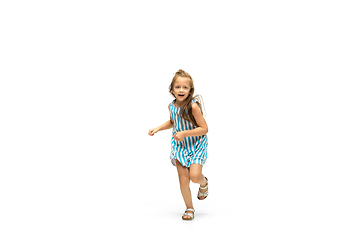 Image showing Happy little caucasian girl jumping and running isolated on white background