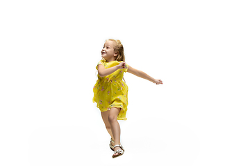 Image showing Happy little caucasian girl jumping and running isolated on white background