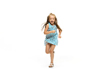 Image showing Happy little caucasian girl jumping and running isolated on white background