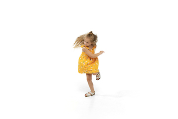 Image showing Happy little caucasian girl jumping and running isolated on white background