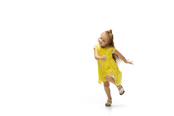 Image showing Happy little caucasian girl jumping and running isolated on white background