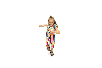 Image showing Happy little caucasian girl jumping and running isolated on white background