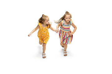 Image showing Happy little caucasian girls jumping and running isolated on white background