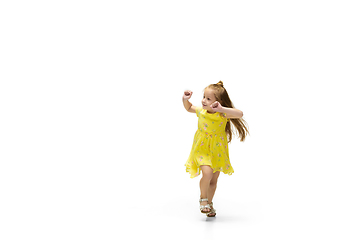 Image showing Happy little caucasian girl jumping and running isolated on white background