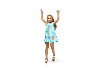 Image showing Happy little caucasian girl jumping and running isolated on white background