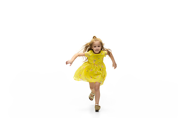 Image showing Happy little caucasian girl jumping and running isolated on white background