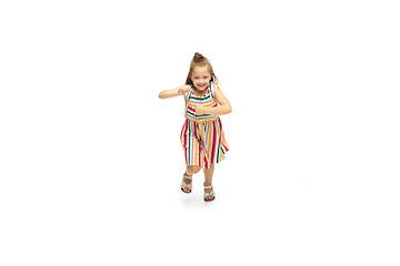 Image showing Happy little caucasian girl jumping and running isolated on white background