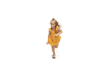 Image showing Happy little caucasian girl jumping and running isolated on white background