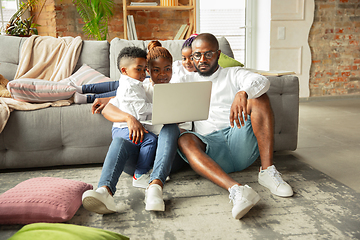 Image showing Young african family during quarantine, insulation spending time together at home