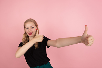 Image showing Young emotional woman on pink studio background. Human emotions, facial expression concept.