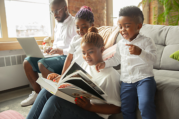 Image showing Young african family during quarantine, insulation spending time together at home