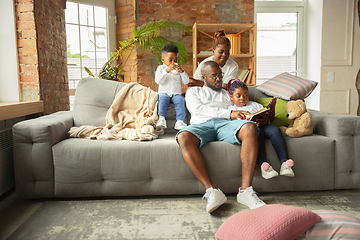 Image showing Young african family during quarantine, insulation spending time together at home