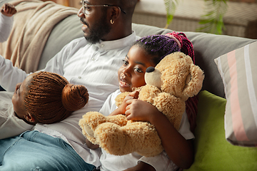 Image showing Young african family during quarantine, insulation spending time together at home