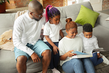 Image showing Young african family during quarantine, insulation spending time together at home