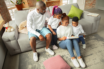 Image showing Young african family during quarantine, insulation spending time together at home