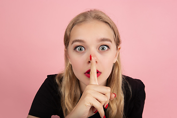 Image showing Young emotional woman on pink studio background. Human emotions, facial expression concept.