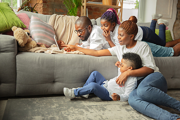 Image showing Young african family during quarantine, insulation spending time together at home