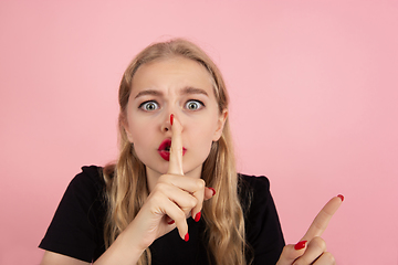 Image showing Young emotional woman on pink studio background. Human emotions, facial expression concept.