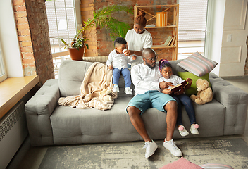 Image showing Young african family during quarantine, insulation spending time together at home