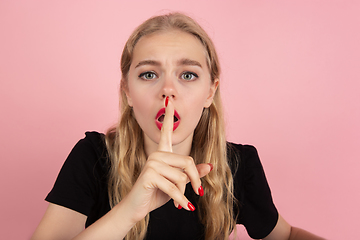 Image showing Young emotional woman on pink studio background. Human emotions, facial expression concept.