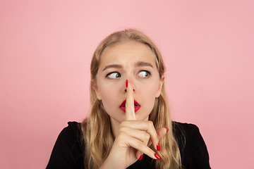 Image showing Young emotional woman on pink studio background. Human emotions, facial expression concept.