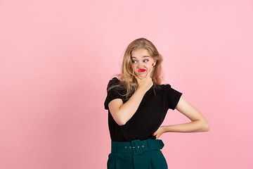 Image showing Young emotional woman on pink studio background. Human emotions, facial expression concept.