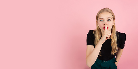 Image showing Young emotional woman on pink studio background. Human emotions, facial expression concept.