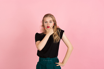 Image showing Young emotional woman on pink studio background. Human emotions, facial expression concept.