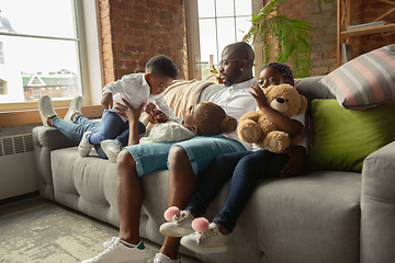 Image showing Young african family during quarantine, insulation spending time together at home